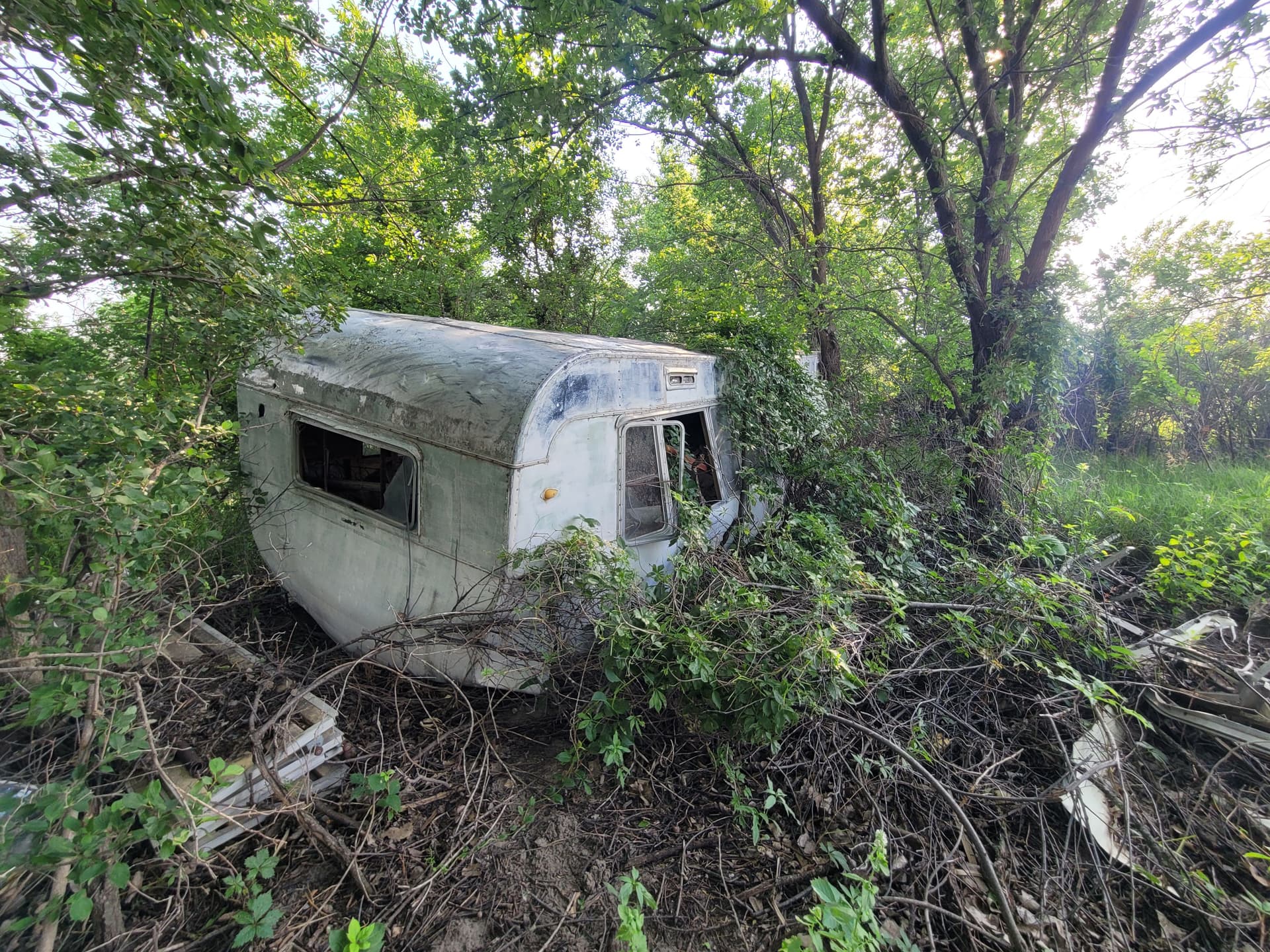 Abandoned Camper and Junk Hauled Out From Along the River image
