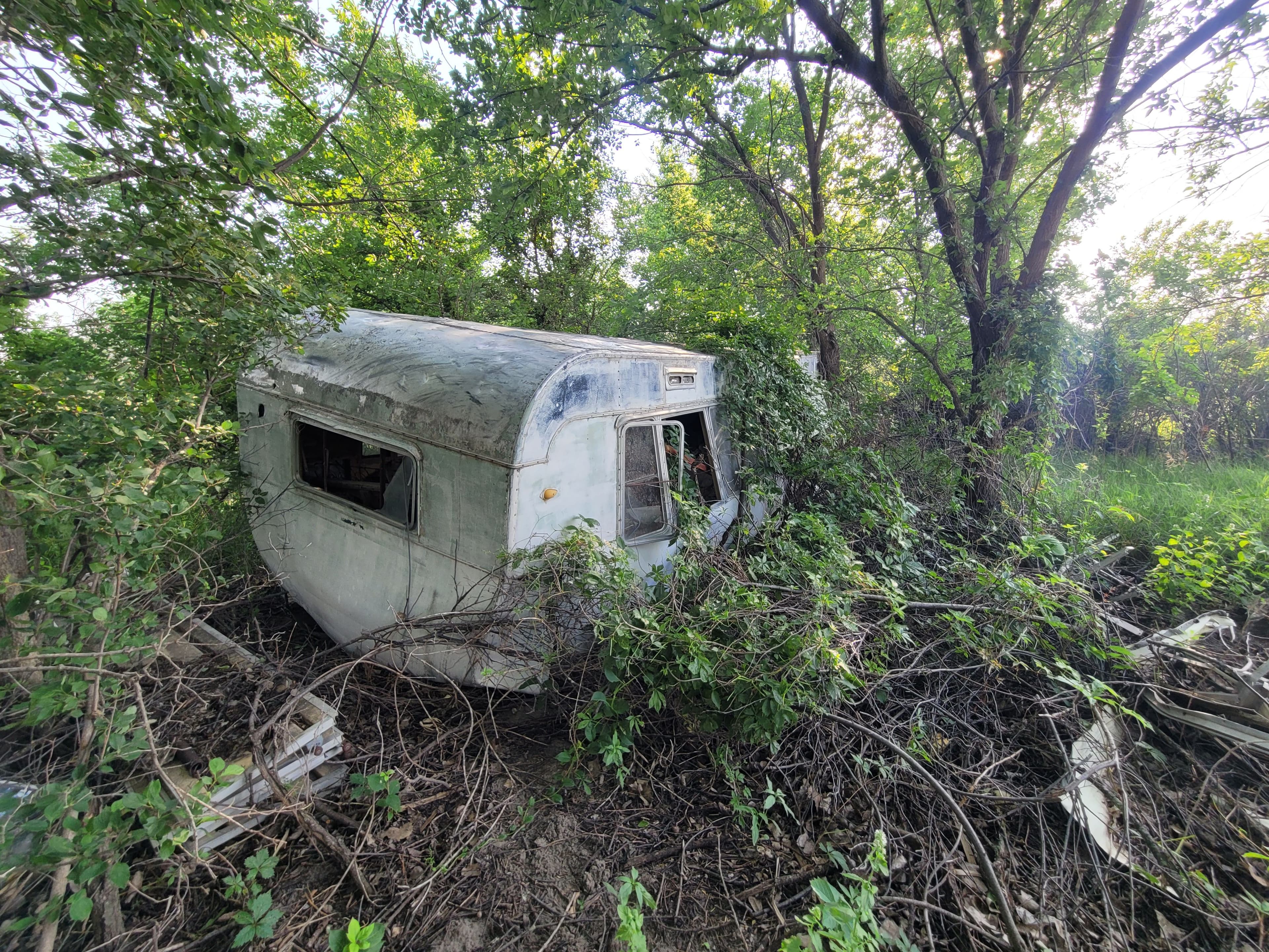 Project Abandoned Camper and Junk Hauled Out From Along the River image